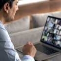 man on a laptop displaying a Zoom call