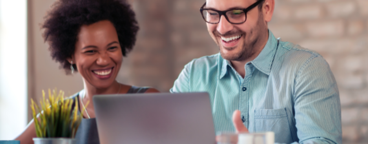 image of two people working together on a laptop