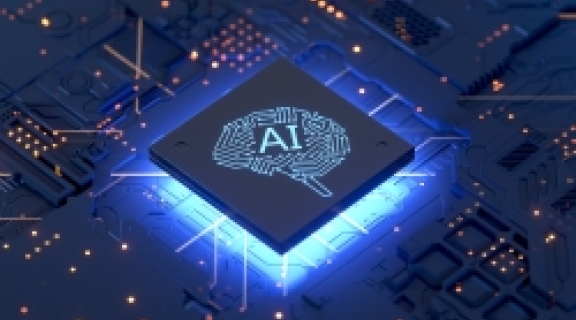 stock image of computer circuitry with a glowing chip that reads "AI" in the center